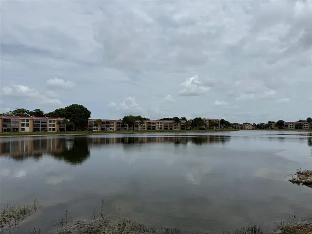 a view of a lake with houses in back