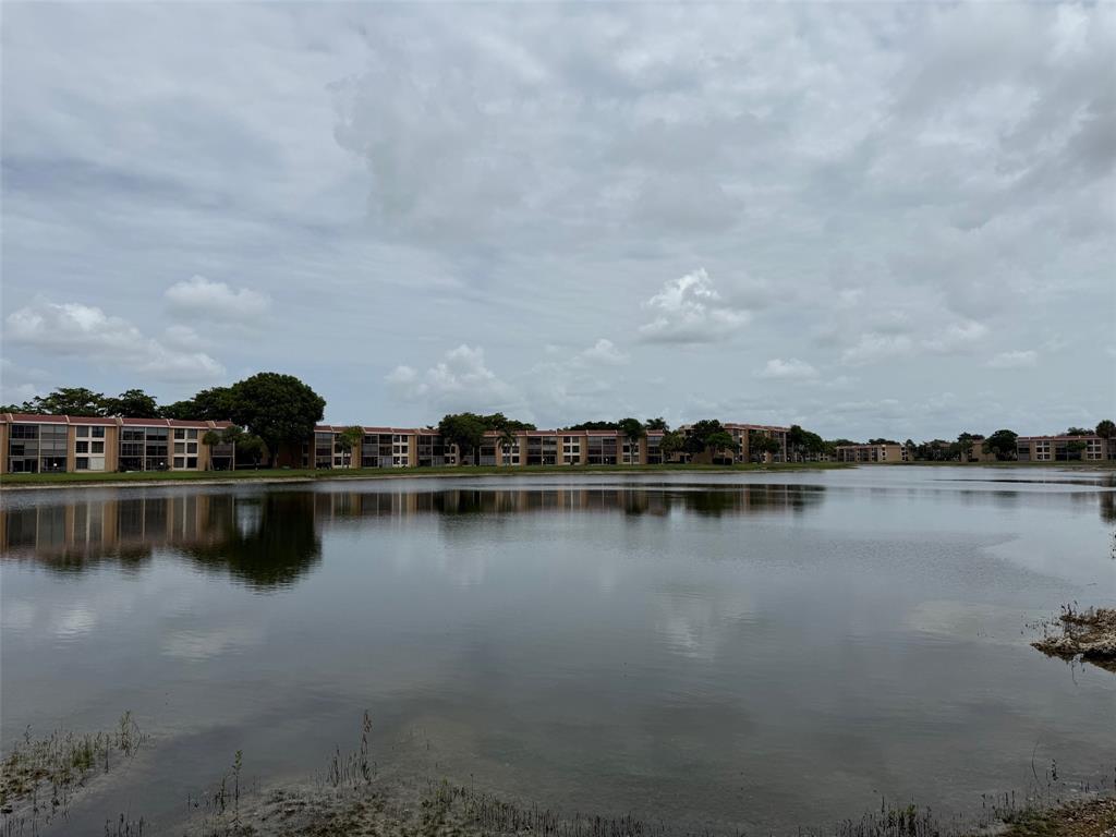 6215 Coral Lake Drive, Unit 203 Margate, FL 33063 - Photo 38 of 46 a view of a lake with houses in back