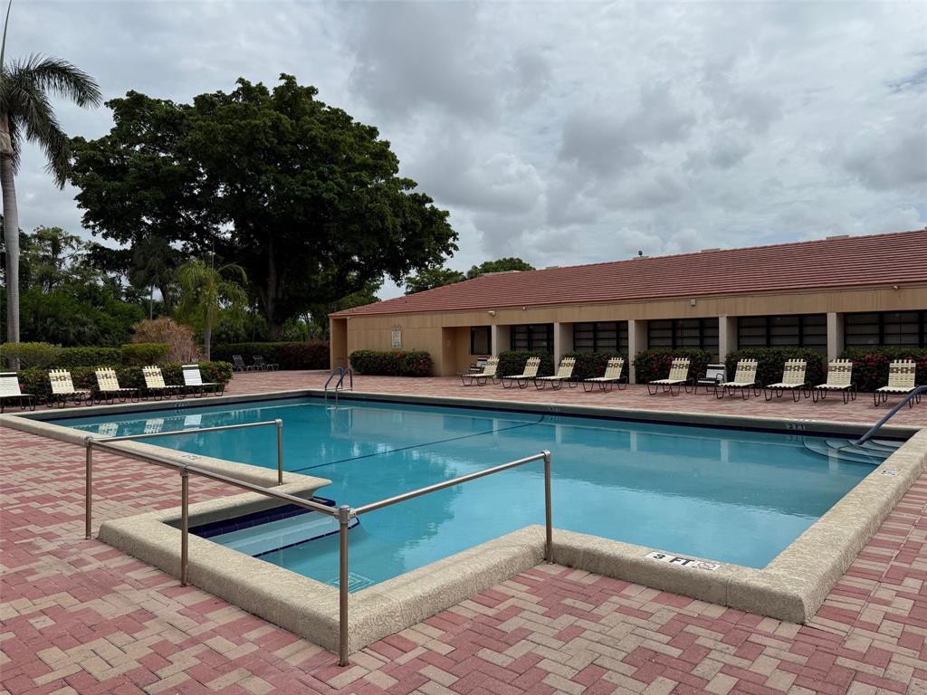 6215 Coral Lake Drive, Unit 203 Margate, FL 33063 - Photo 39 of 46 a balcony with a table and chairs