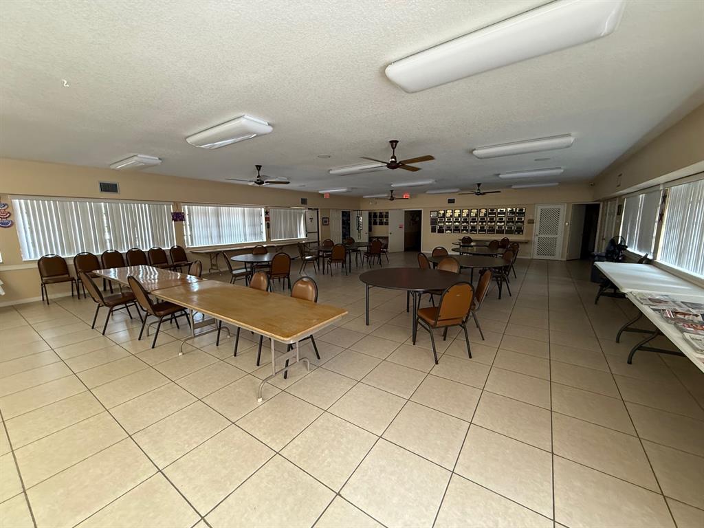 6215 Coral Lake Drive, Unit 203 Margate, FL 33063 - Photo 44 of 46 a living room with furniture a table and chairs