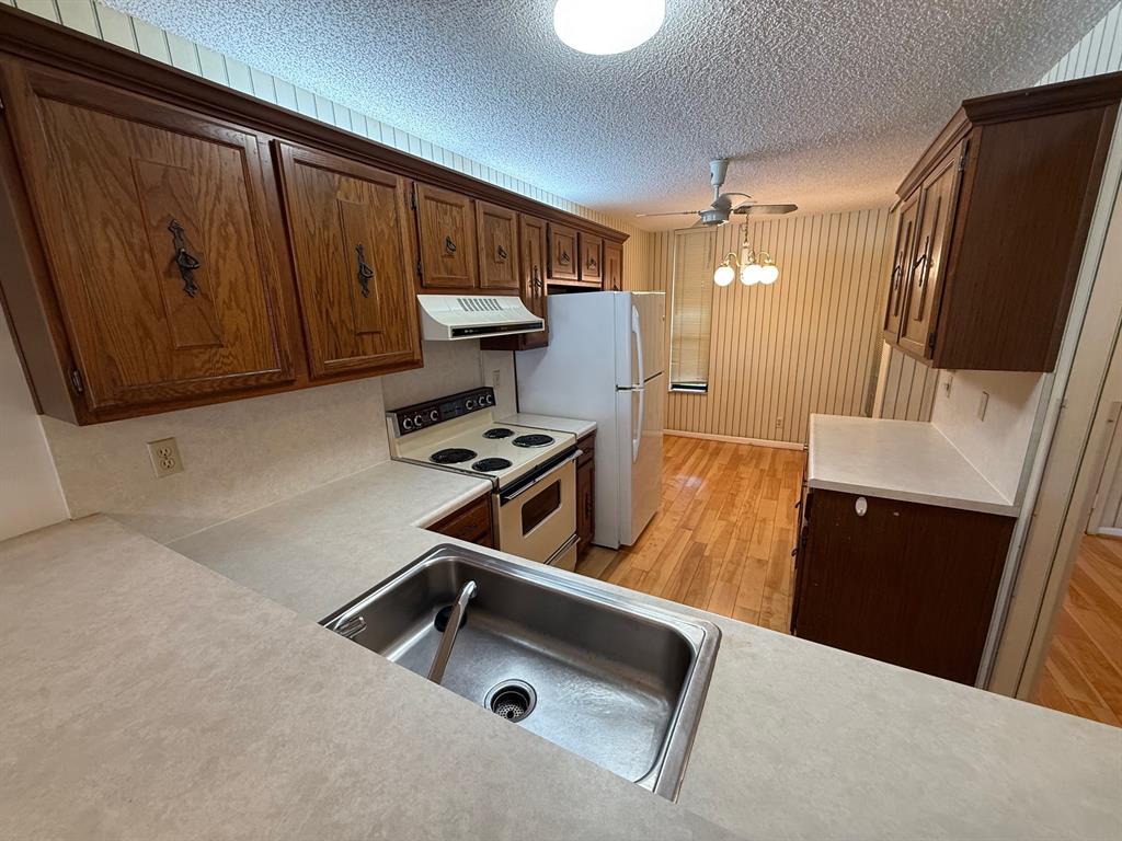 6215 Coral Lake Drive, Unit 203 Margate, FL 33063 - Photo 6 of 46 a room with furniture and a flat screen tv