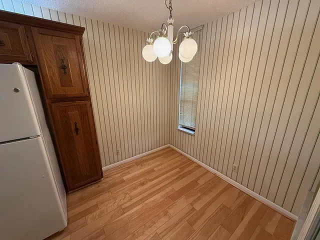 a view of a room with wooden floor and staircase