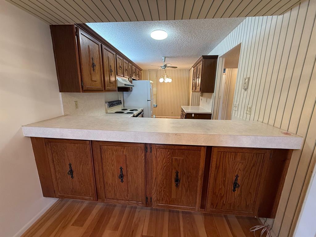 6215 Coral Lake Drive, Unit 203 Margate, FL 33063 - Photo 8 of 46 a kitchen with a sink and wooden cabinets