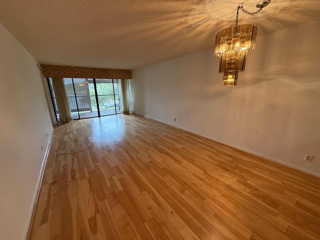 6215 Coral Lake Drive, Unit 203 Margate, FL 33063 - Photo 9 of 46 wooden floor in an empty room with a window