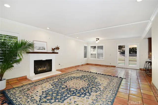 a living room with a rug and a fireplace
