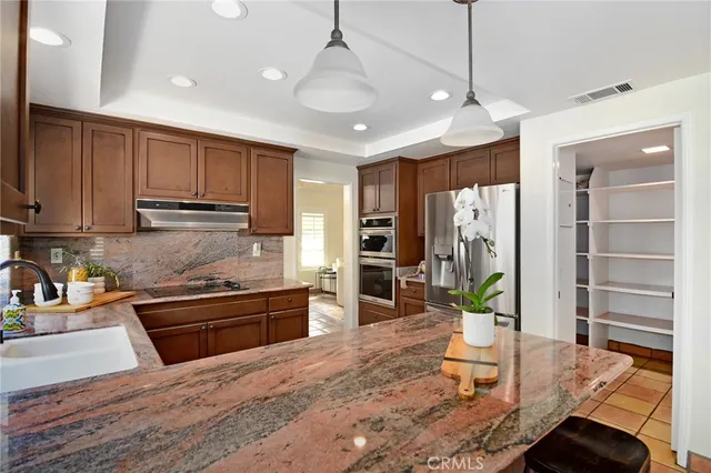 a kitchen with a sink a counter and cabinets