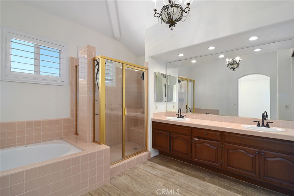 951 Firestone Circle Simi Valley, CA 93065 - Photo 22 of 41 a bathroom with a double vanity sink a large mirror and a bathtub