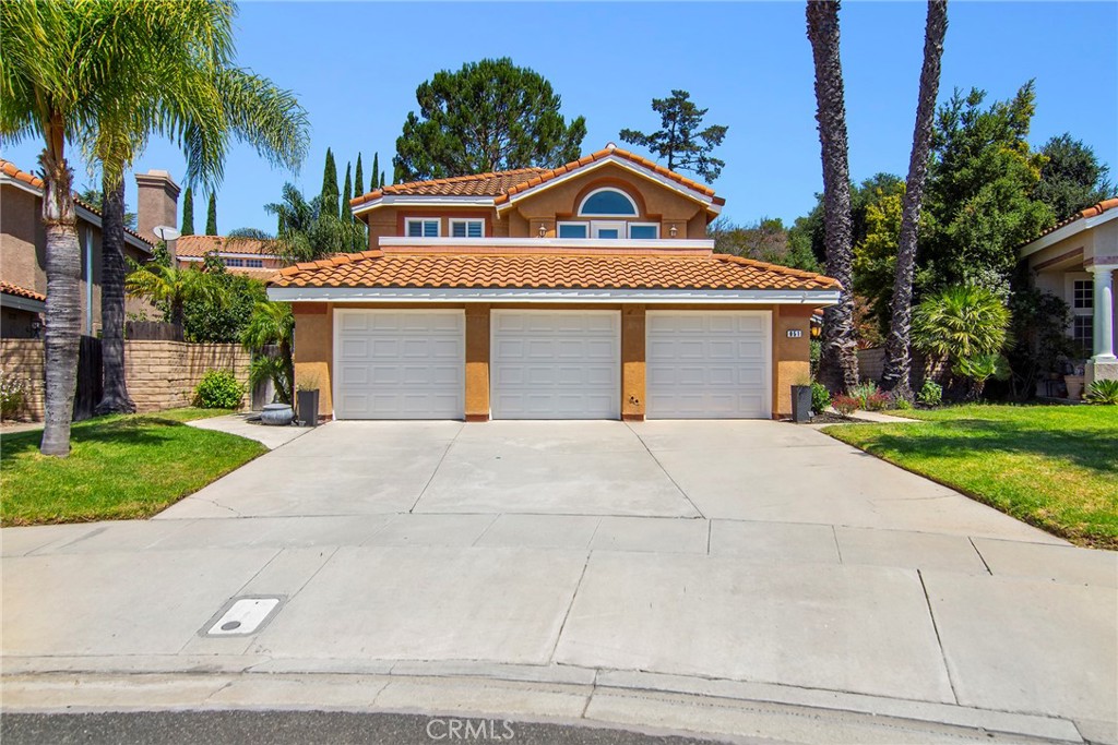 951 Firestone Circle Simi Valley, CA 93065 - Photo 3 of 41 a front view of a house with a yard and garage