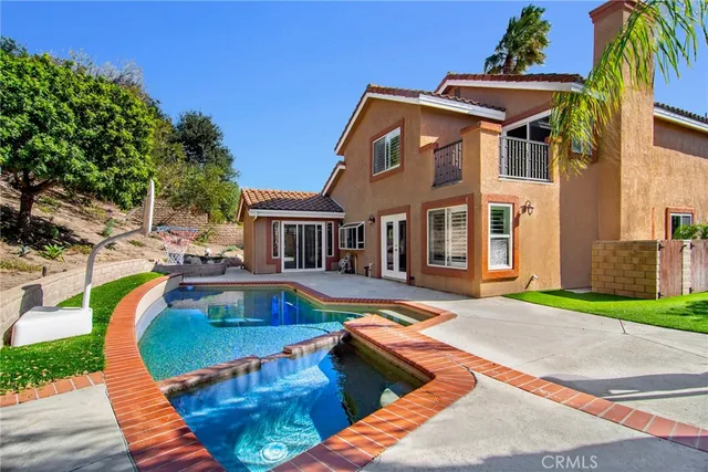 a view of a backyard with swimming pool