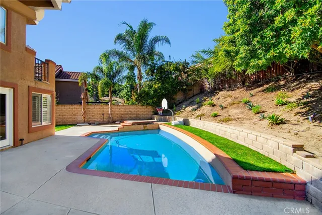a view of a house with swimming pool and sitting area