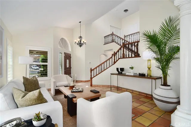 a living room with furniture and a potted plant