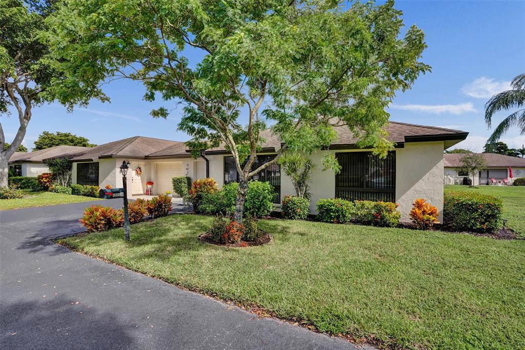 4840 Greentree Lane, Unit B Boynton Beach, FL 33436 - Photo 1 of 68 a front view of a house with a yard and porch
