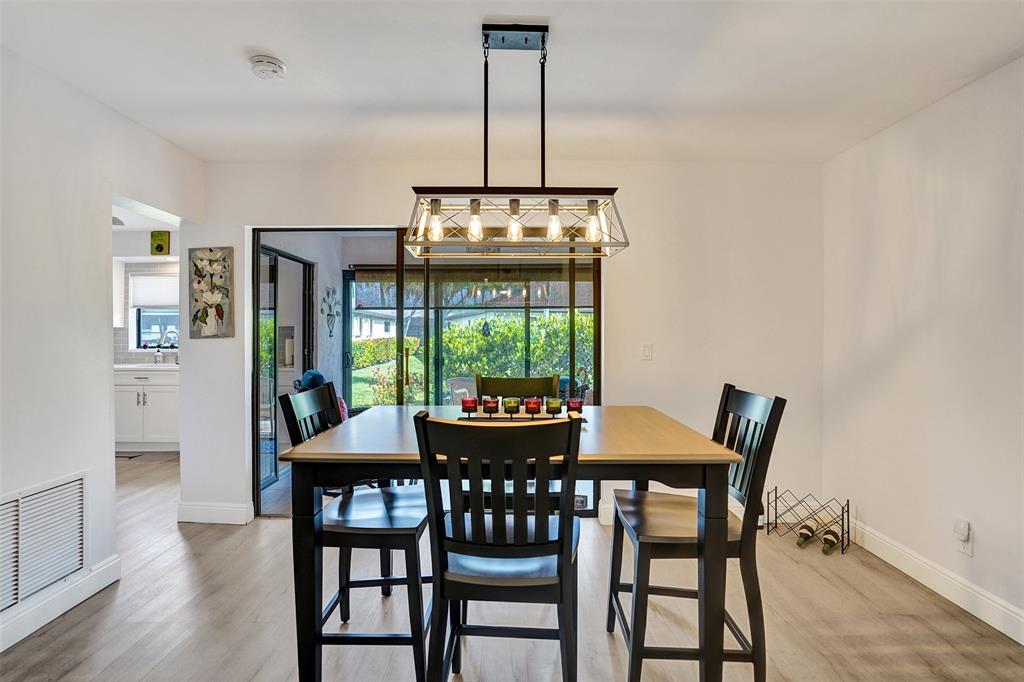 4840 Greentree Lane, Unit B Boynton Beach, FL 33436 - Photo 12 of 68 a view of a dining room with furniture window and wooden floor