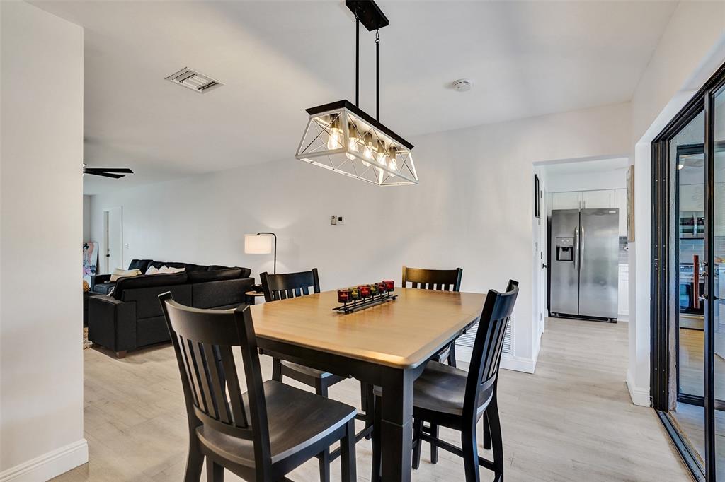 4840 Greentree Lane, Unit B Boynton Beach, FL 33436 - Photo 15 of 68 a dining room with a wooden table and chairs