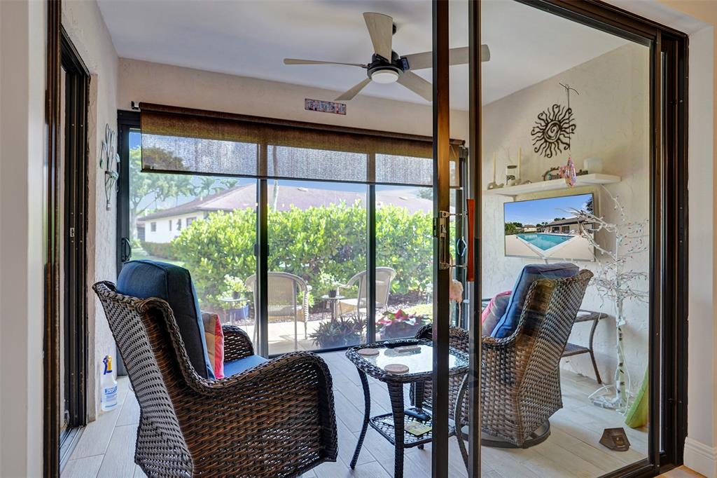 4840 Greentree Lane, Unit B Boynton Beach, FL 33436 - Photo 17 of 68 a balcony view with a large window and dining table