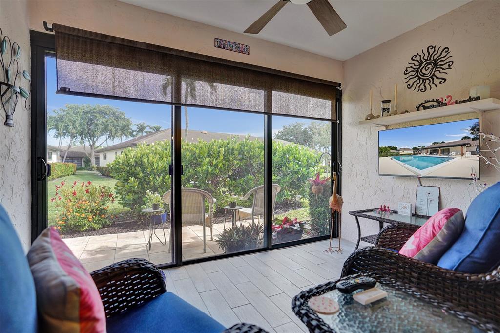 4840 Greentree Lane, Unit B Boynton Beach, FL 33436 - Photo 18 of 68 a living room with furniture and a floor to ceiling window
