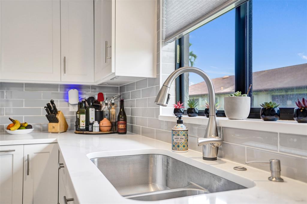 4840 Greentree Lane, Unit B Boynton Beach, FL 33436 - Photo 21 of 68 a kitchen with sink a stove and cabinets
