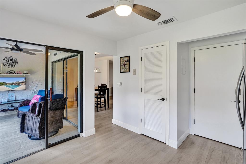 4840 Greentree Lane, Unit B Boynton Beach, FL 33436 - Photo 25 of 68 a view of a livingroom with wooden floor and a ceiling fan