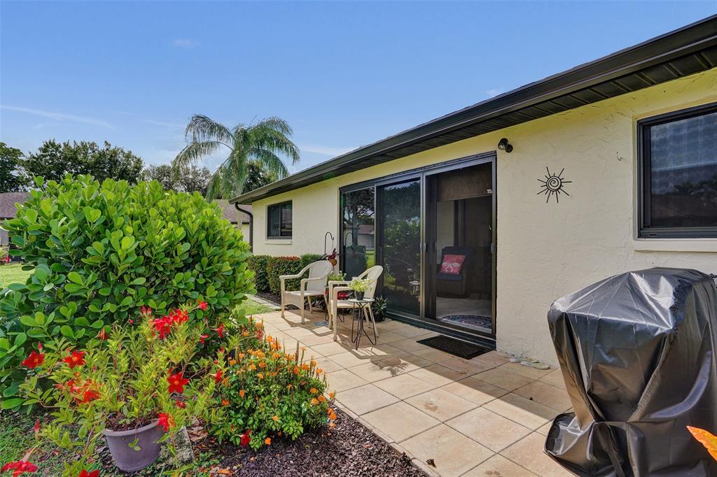 4840 Greentree Lane, Unit B Boynton Beach, FL 33436 - Photo 27 of 68 a front view of a house with outdoor seating and a potted plant