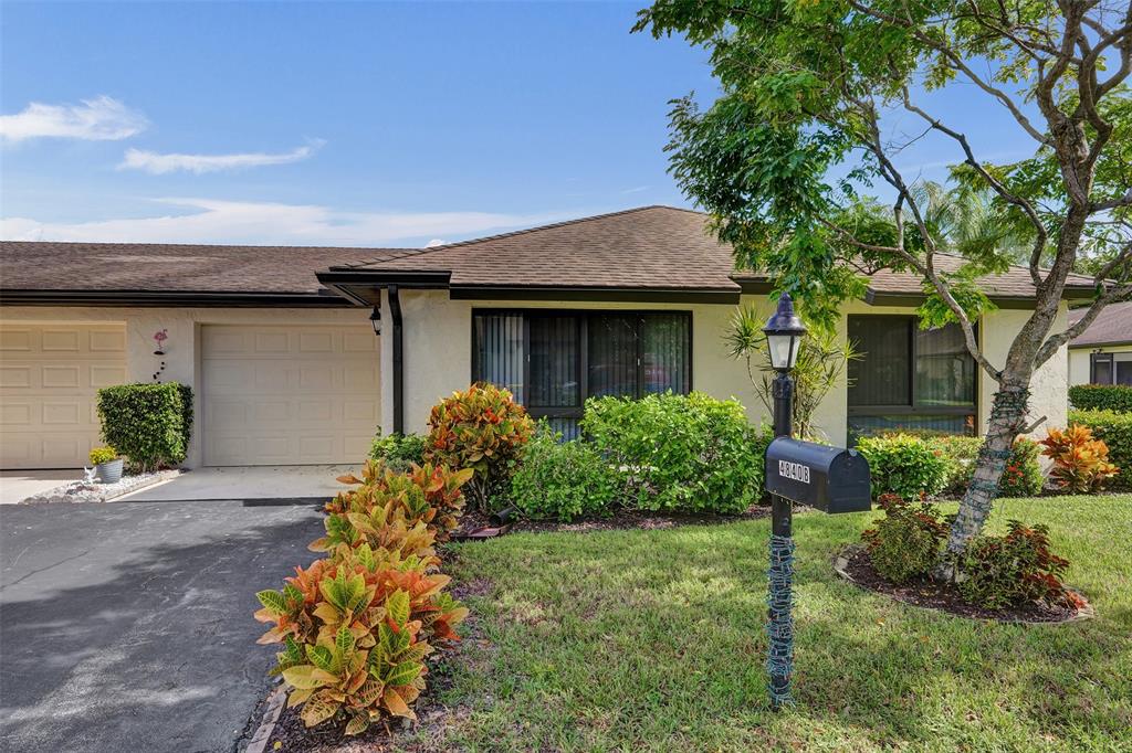 4840 Greentree Lane, Unit B Boynton Beach, FL 33436 - Photo 3 of 68 a front view of a house with a yard