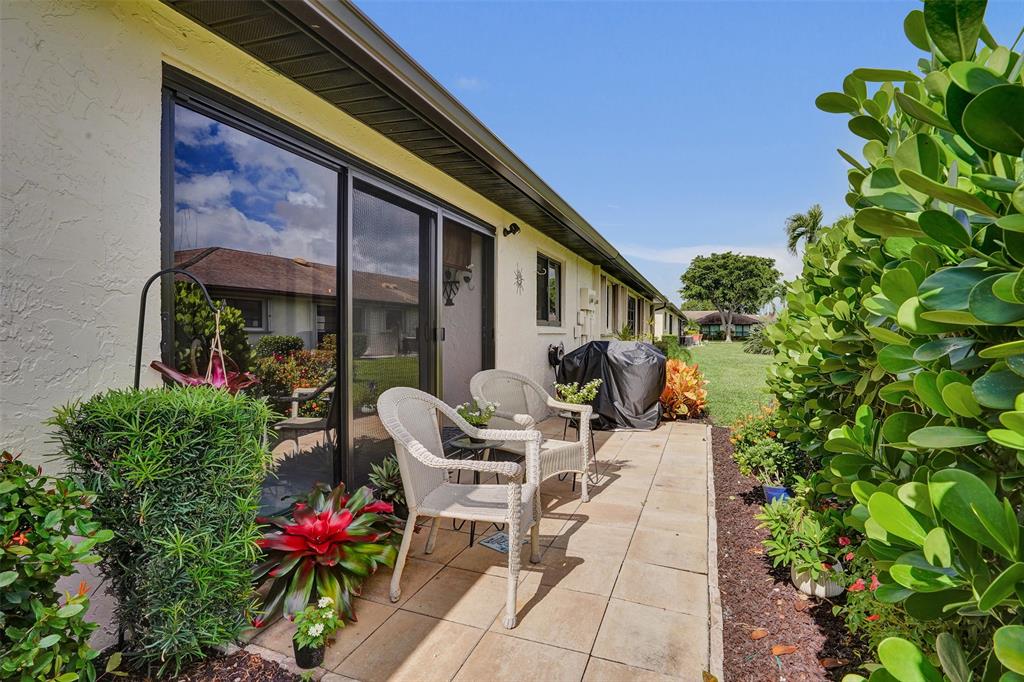 4840 Greentree Lane, Unit B Boynton Beach, FL 33436 - Photo 31 of 68 a view of a chairs and table in a patio
