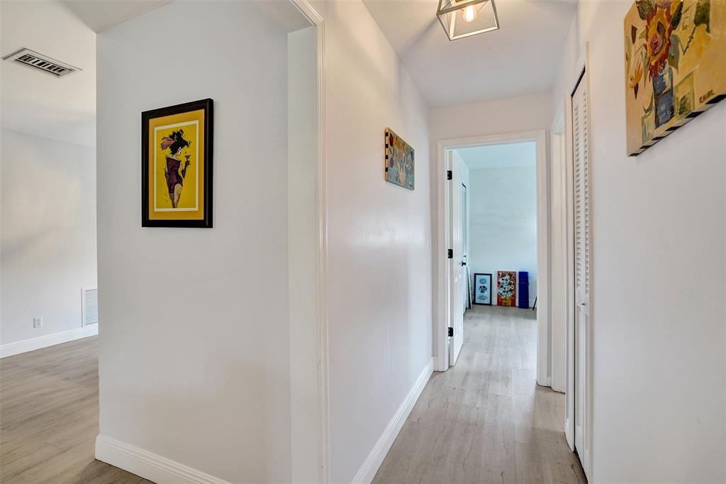 4840 Greentree Lane, Unit B Boynton Beach, FL 33436 - Photo 34 of 68 a view of a hallway with wooden floor and closet