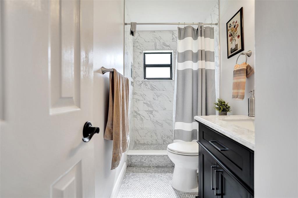 4840 Greentree Lane, Unit B Boynton Beach, FL 33436 - Photo 36 of 68 a bathroom with a granite countertop sink a toilet a mirror and shower