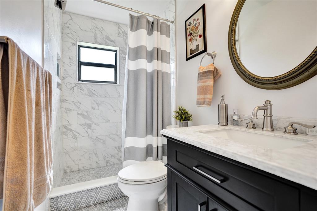 4840 Greentree Lane, Unit B Boynton Beach, FL 33436 - Photo 37 of 68 a bathroom with a granite countertop sink a toilet and a mirror
