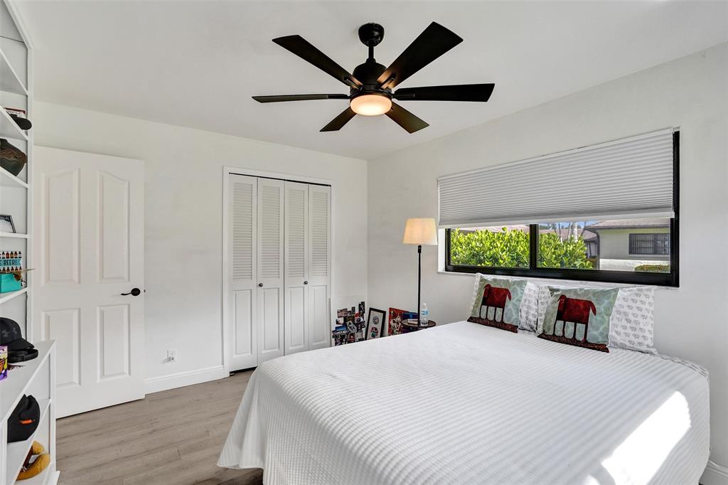 4840 Greentree Lane, Unit B Boynton Beach, FL 33436 - Photo 41 of 68 a bedroom with a bed and a large window