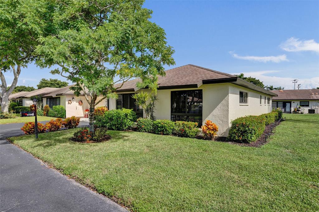 4840 Greentree Lane, Unit B Boynton Beach, FL 33436 - Photo 55 of 68 a front view of a house with a yard