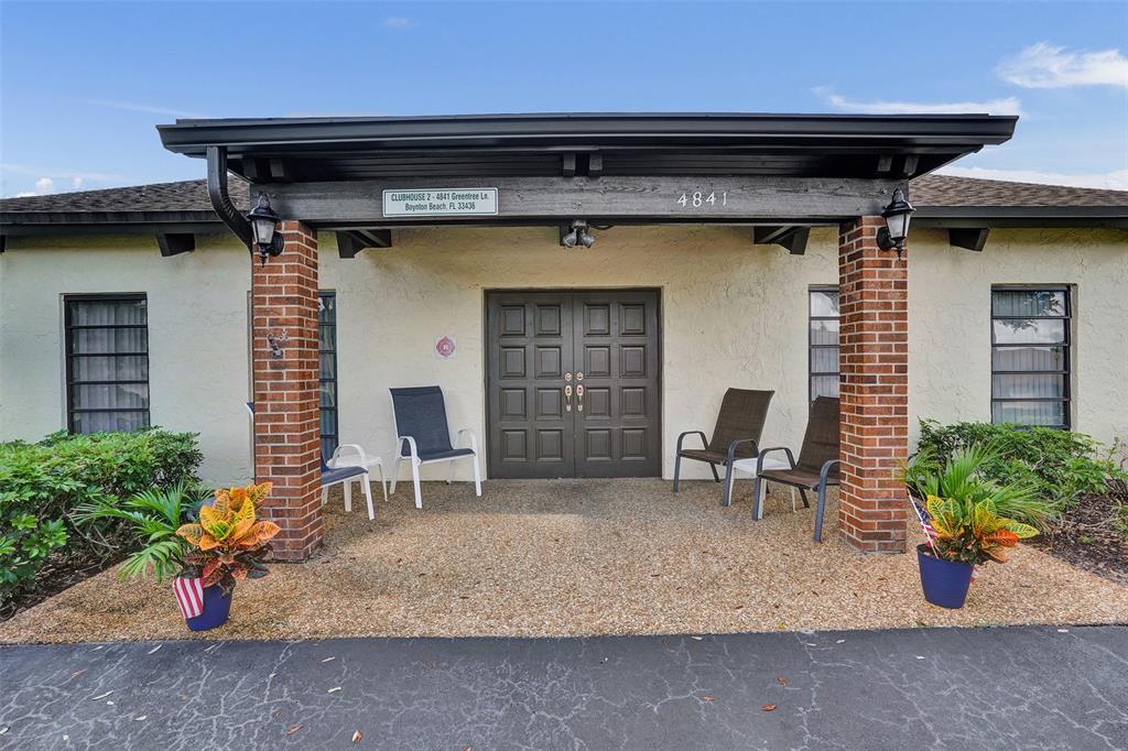 4840 Greentree Lane, Unit B Boynton Beach, FL 33436 - Photo 56 of 68 a front view of a house with outdoor seating