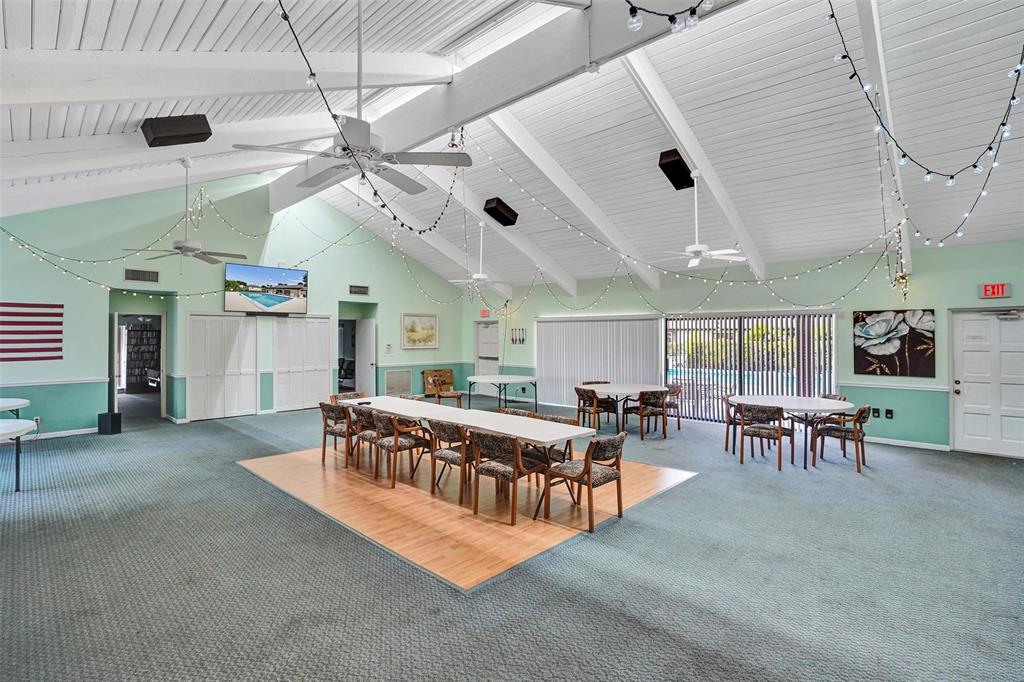 4840 Greentree Lane, Unit B Boynton Beach, FL 33436 - Photo 63 of 68 a living room with lots of furniture and a chandelier