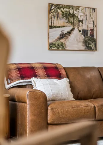 a living room with a couch and wall painting