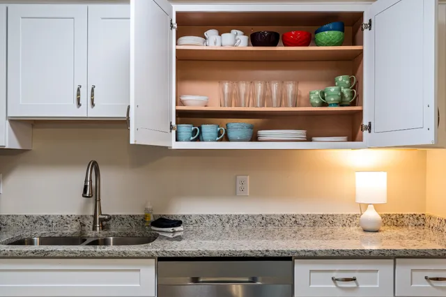 a kitchen with a sink and wooden floor