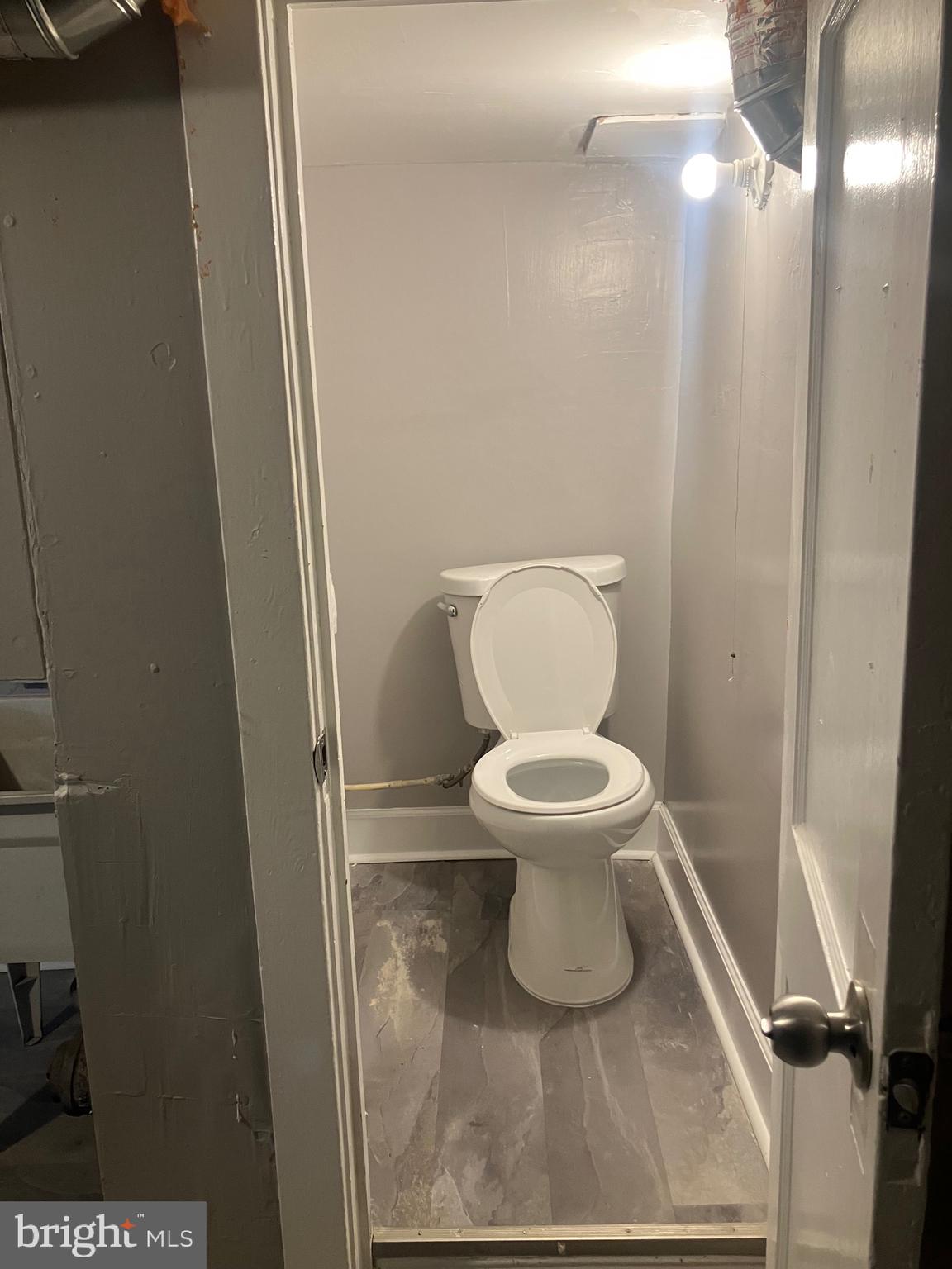 2540 Aisquith Street Baltimore, MD 21218 - Photo 13 of 15 a bathroom with a toilet and a mirror