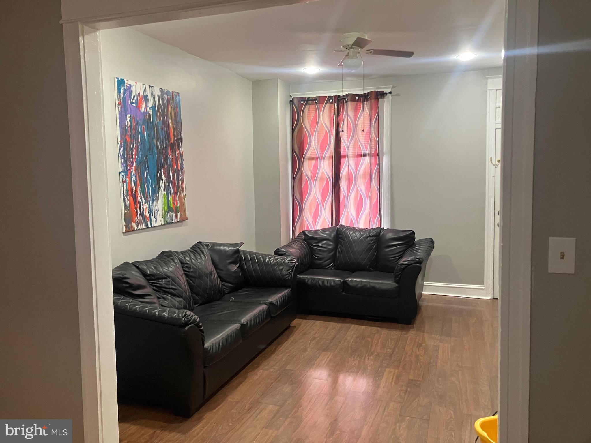 2540 Aisquith Street Baltimore, MD 21218 - Photo 2 of 15 a living room with furniture and a window