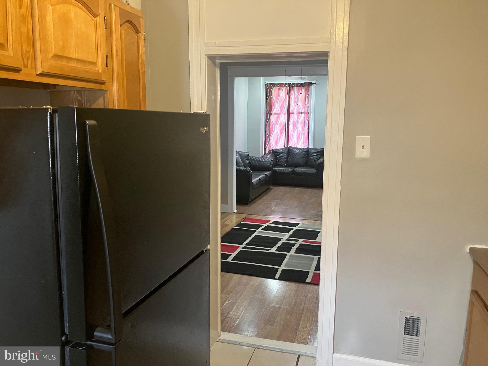2540 Aisquith Street Baltimore, MD 21218 - Photo 5 of 15 a kitchen with a refrigerator and a stove