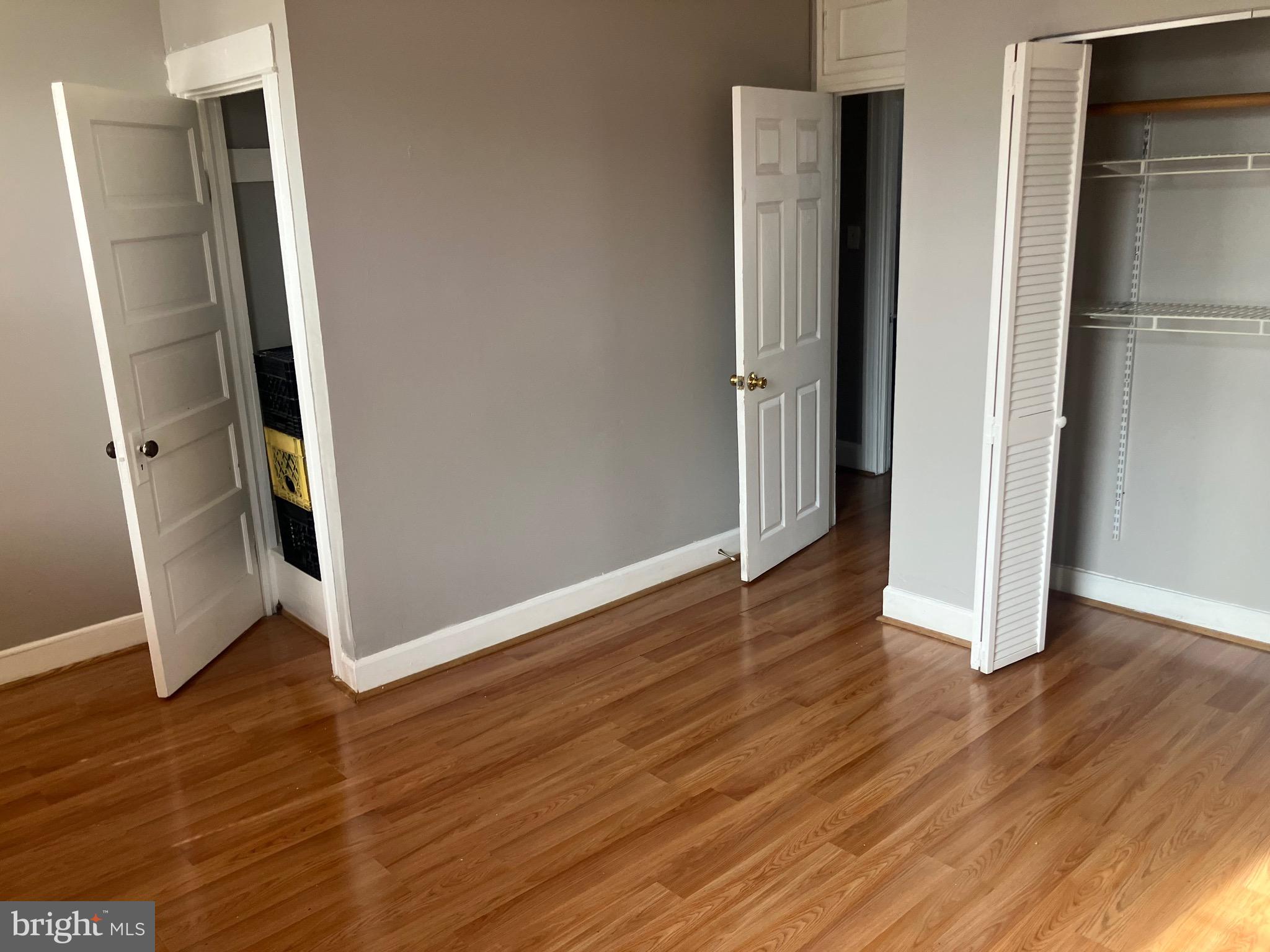2540 Aisquith Street Baltimore, MD 21218 - Photo 9 of 15 an empty room with wooden floor and entrance