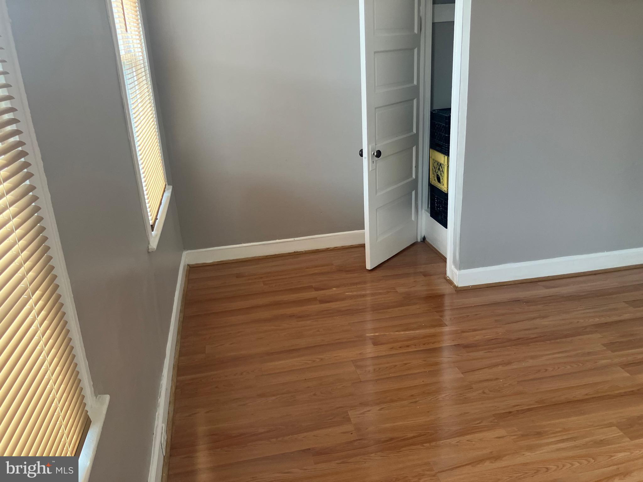 2540 Aisquith Street Baltimore, MD 21218 - Photo 10 of 15 an empty room with wooden floor and entrance