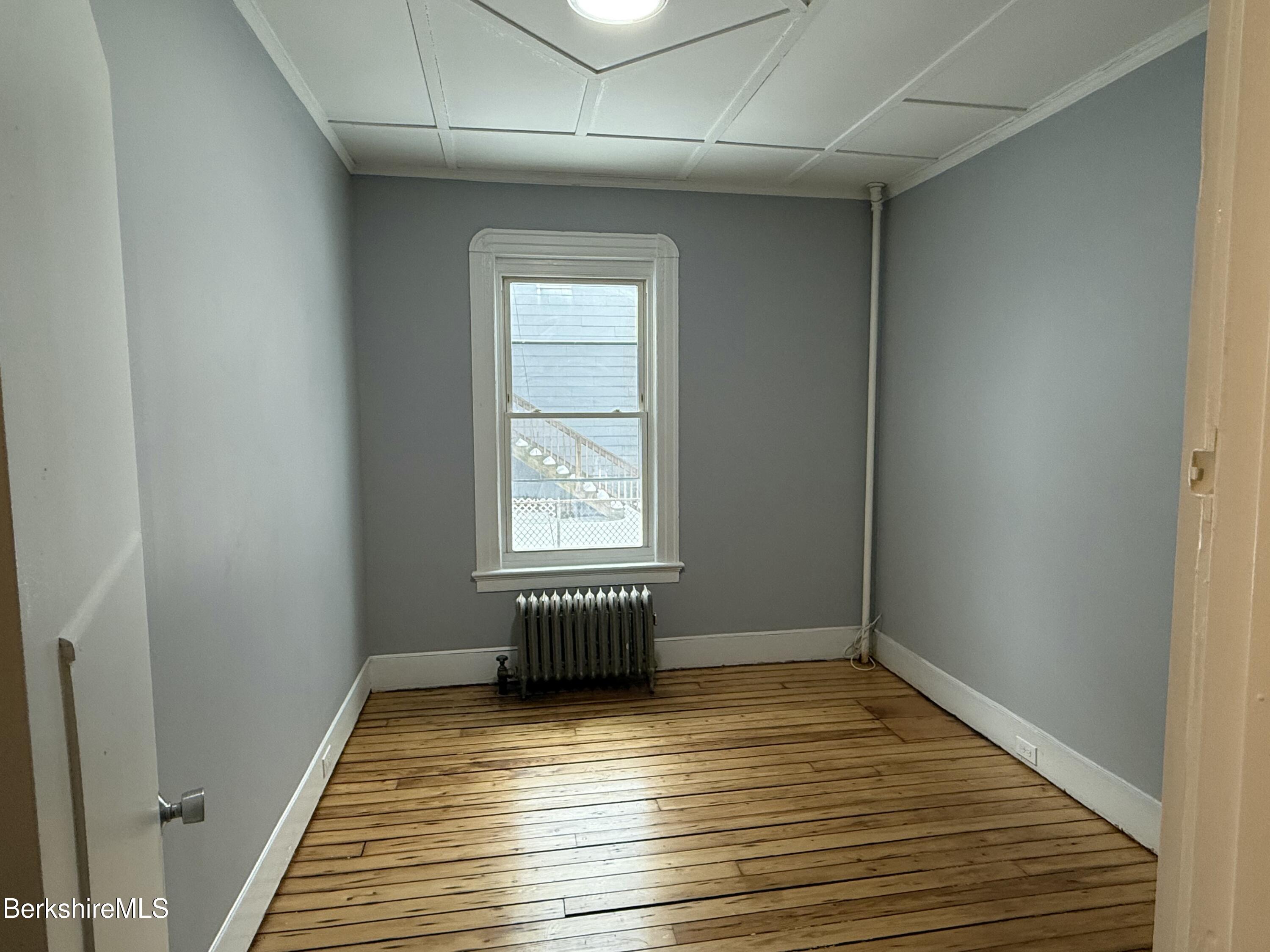 126 Appleton Avenue, Unit 1 Pittsfield, MA 01201 - Photo 2 of 8 a view of empty room with wooden floor