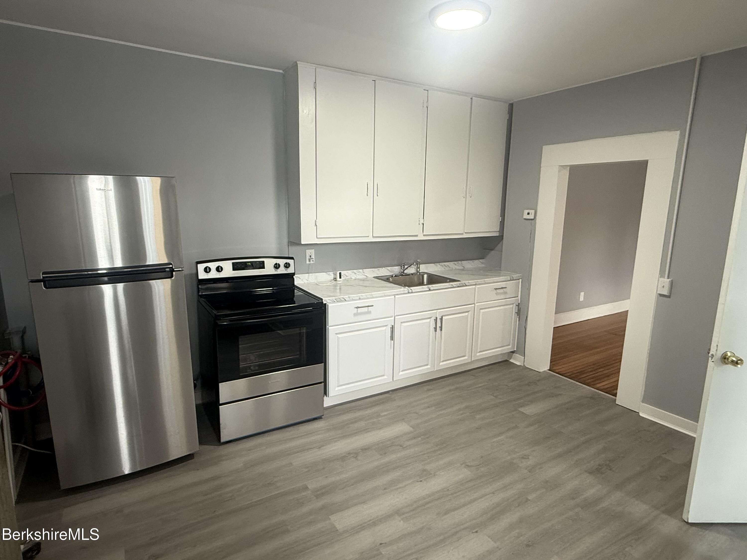 126 Appleton Avenue, Unit 1 Pittsfield, MA 01201 - Photo 5 of 8 a kitchen with a stove a refrigerator and a sink