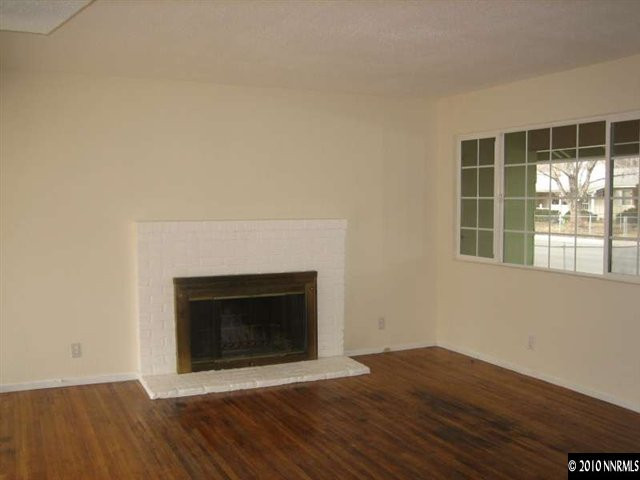 2390 East 9th Street Reno, NV 89512 - Photo 3 of 7 a view of an empty room with wooden floor and a window