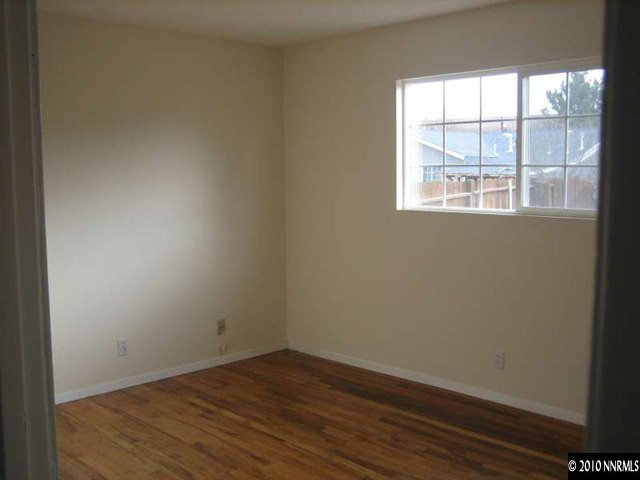 2390 East 9th Street Reno, NV 89512 - Photo 6 of 7 an empty room with wooden floor and windows