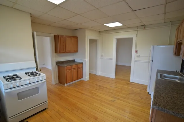 a kitchen with stainless steel appliances granite countertop a stove and a refrigerator