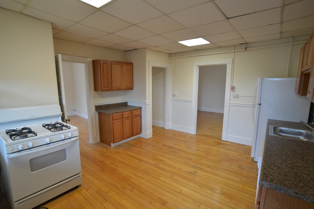 15 Lynde Street, Unit 22 Salem, MA 01970 - Photo 2 of 7 a kitchen with stainless steel appliances granite countertop a stove and a refrigerator
