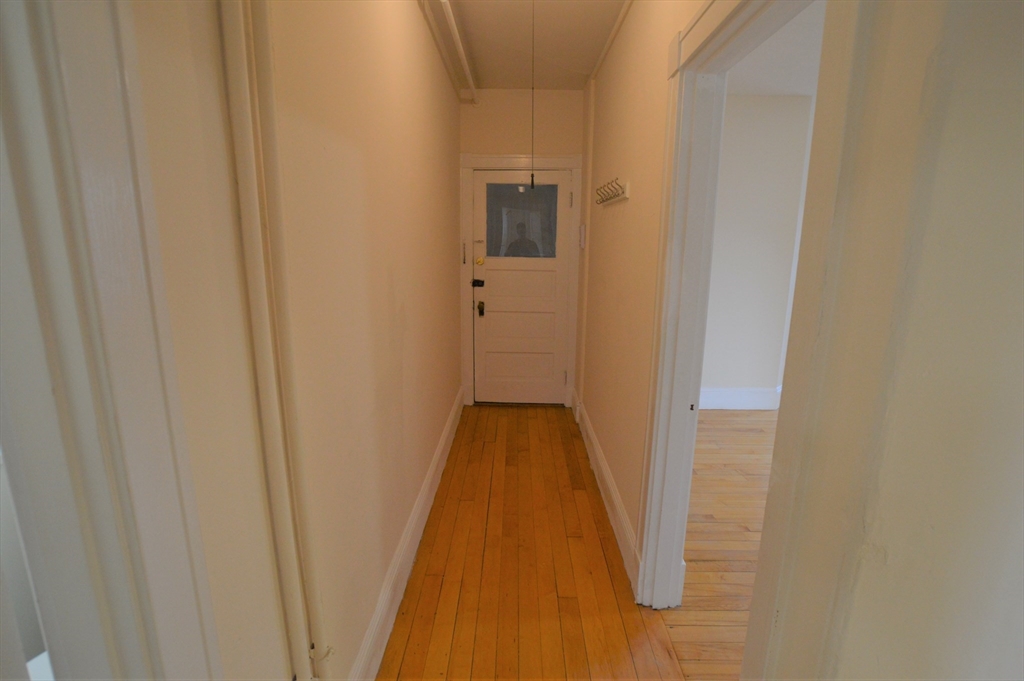 15 Lynde Street, Unit 22 Salem, MA 01970 - Photo 5 of 7 a view of a hallway with wooden floor