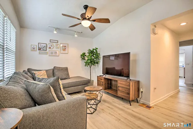 a living room with furniture and a flat screen tv