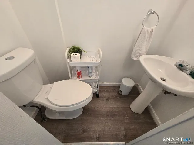 a white toilet sitting next to a bathroom sink