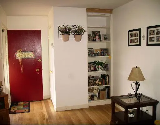 a view of a workspace with furniture and wooden floor