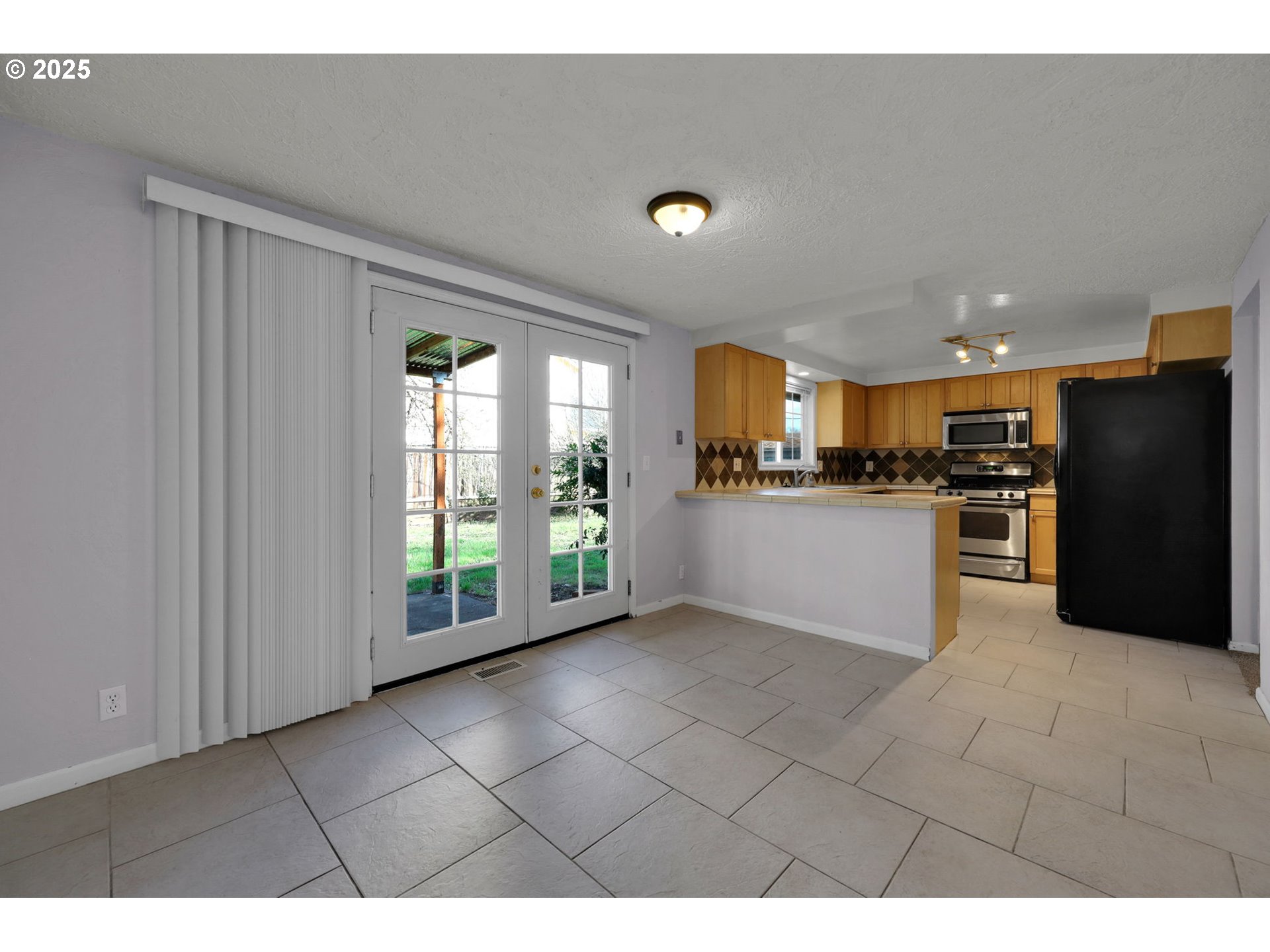 2793 Summer Lane Eugene, OR 97404 - Photo 5 of 15 a kitchen with stainless steel appliances granite countertop a refrigerator and a sink